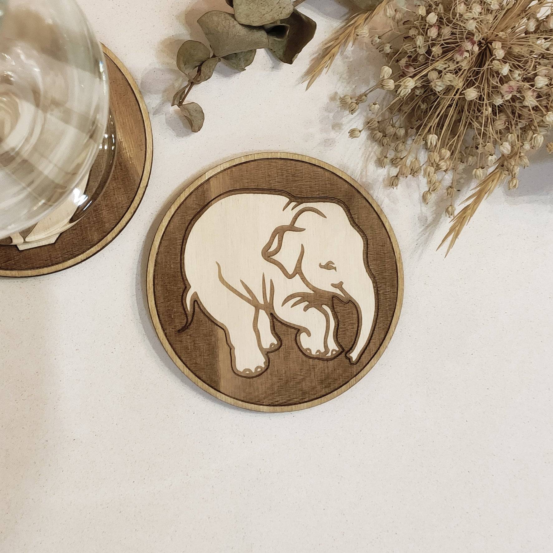 Wooden elephant coasters featuring Carlsberg beer logo, perfect for beer enthusiasts.